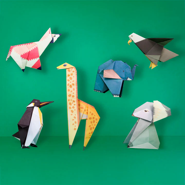 The completed origami pieces on a green background.