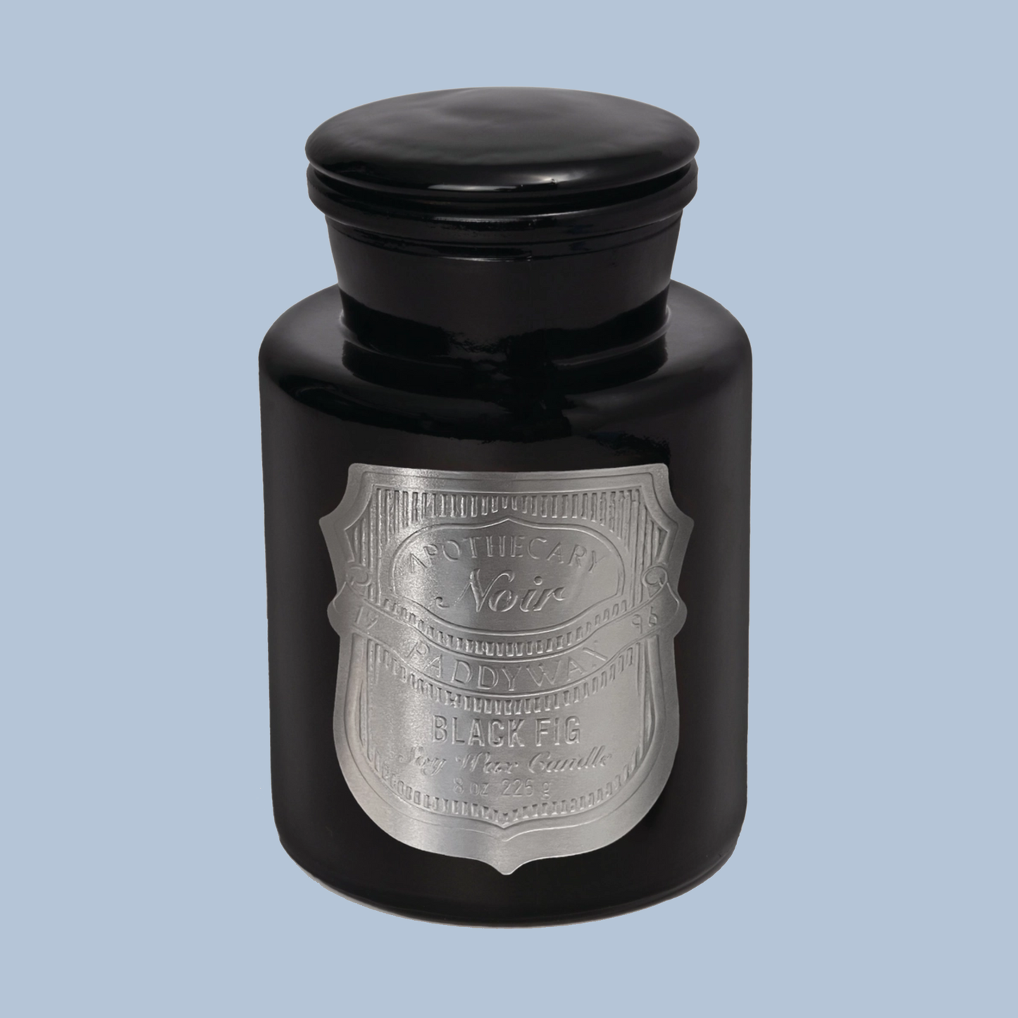 Black candle jar with silver label on a light blue background