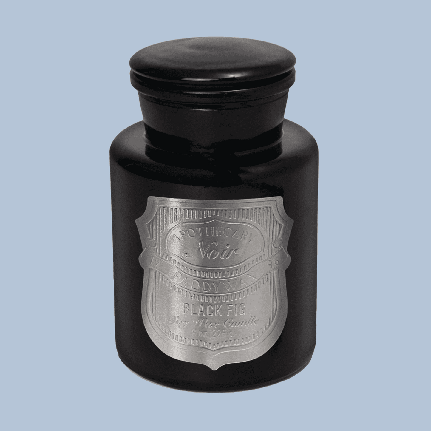 Black candle jar with silver label on a light blue background
