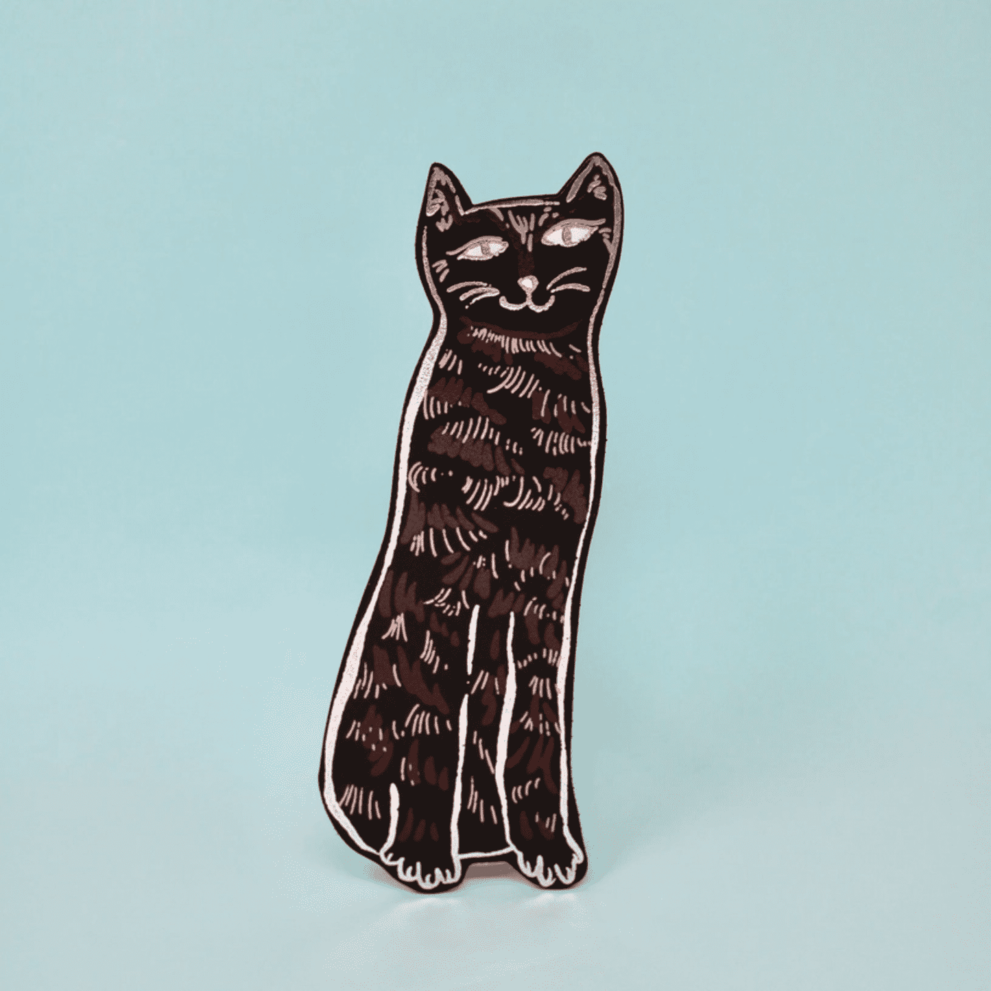 Cat-shaped black bookmark on a light blue background