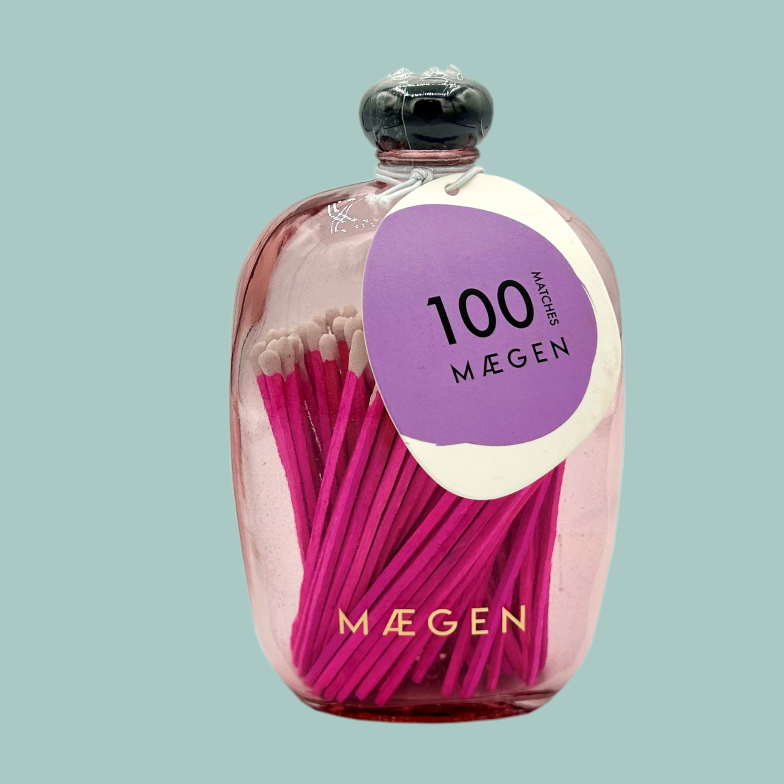 100 pink matches in a pink glass rectangle bottle with rounded edges.