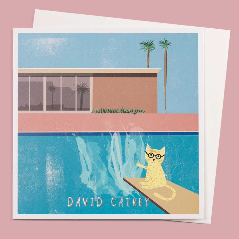 A greeting card featuring a retro-style illustration of a yellow cat wearing glasses on a diving board above a swimming pool, with the text 'DAVID CATNEY' at the bottom. The card is shown against a pink background with a white envelope behind it.