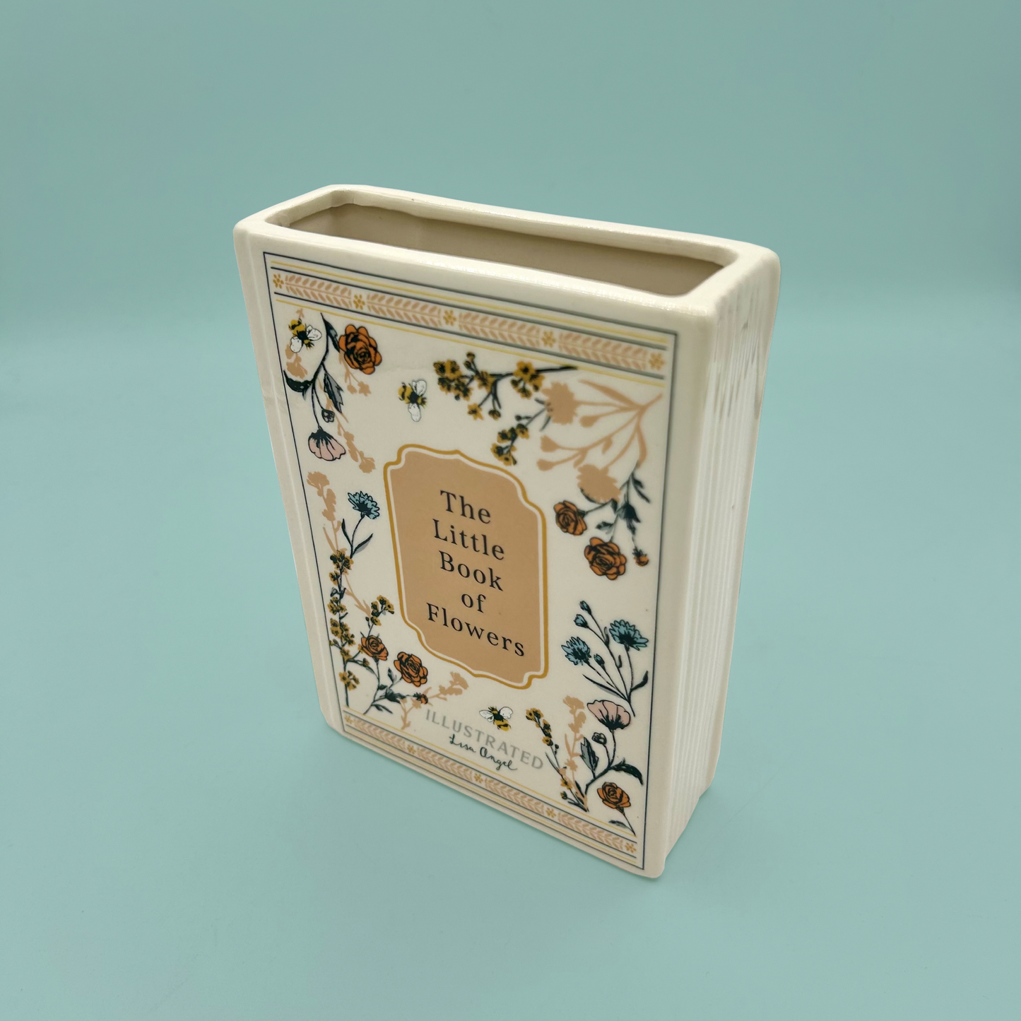Decorative vase with 'The Little Book of Flowers' design on a light blue background