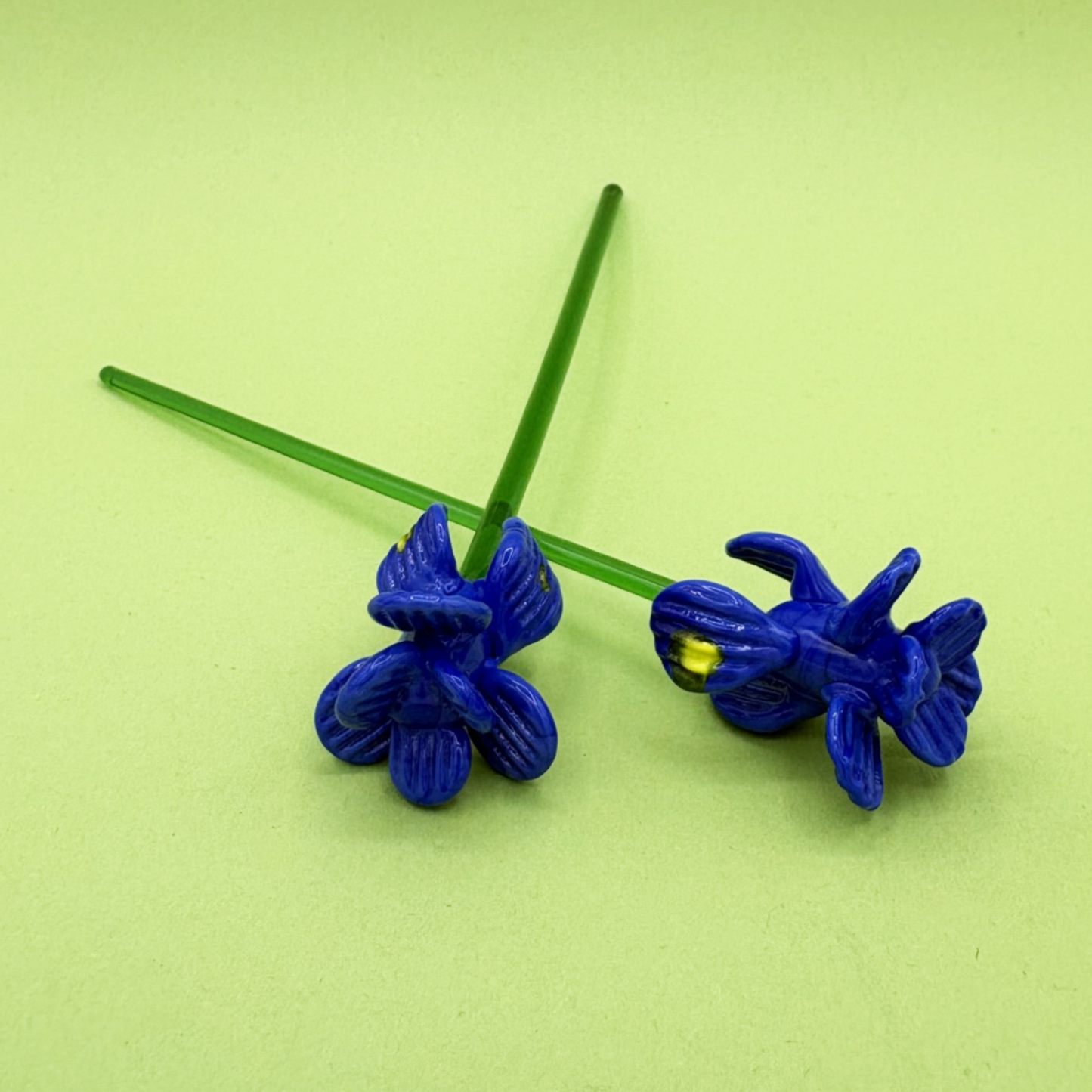 Blue flower-shaped glass objects on a green background
