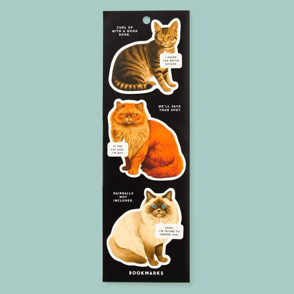 A black rectangular magnet sheet featuring three illustrated cats with humourous text labels, shown on a light blue background. The sheet is labeled 'BOOKMARKS' at the bottom.