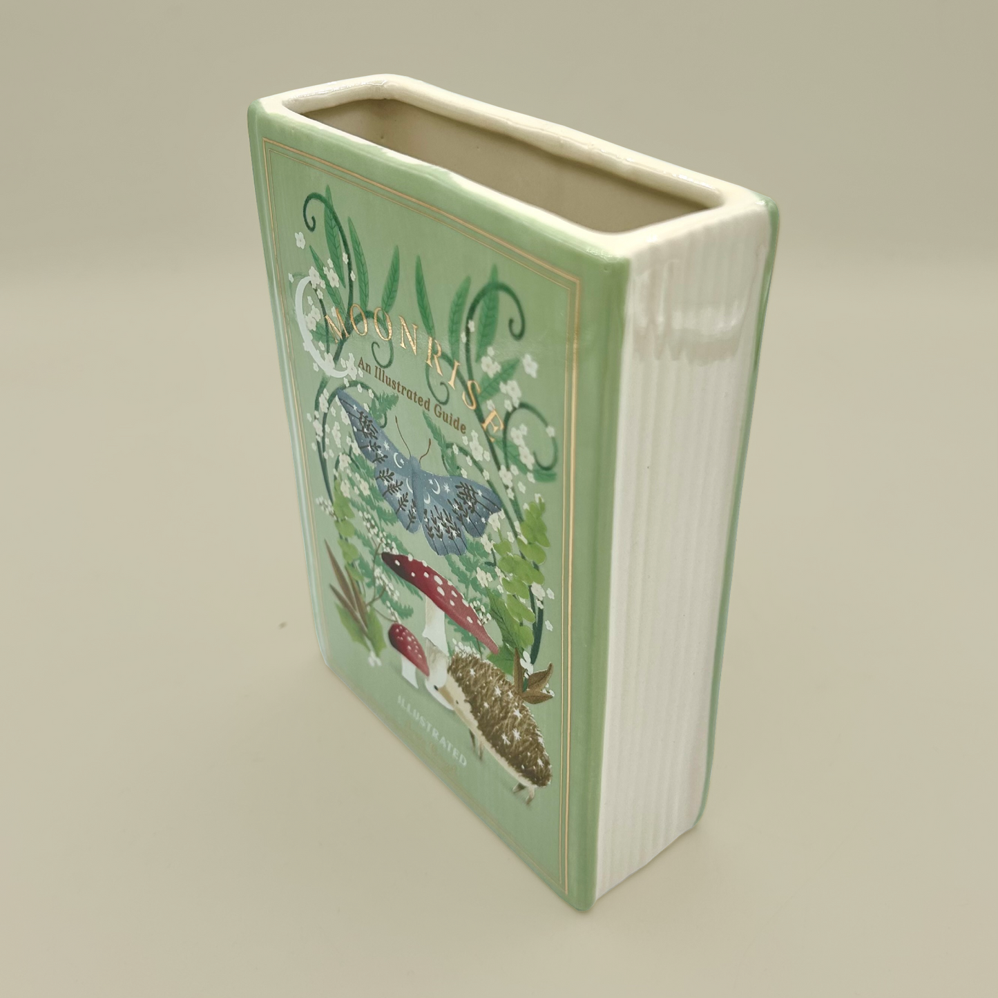Rectangular ceramic vase with floral design on a beige background