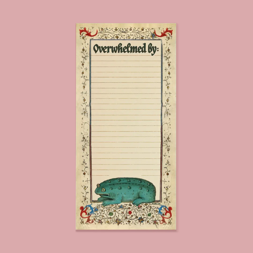 A vintage-style lined notepad with the heading 'Overwhelmed by:' and a decorative border featuring a teal frog at the bottom, shown centered on a dusty pink background.