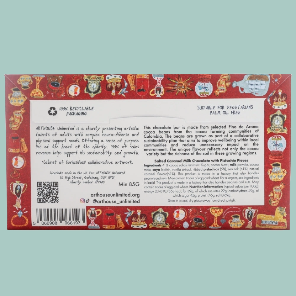 The back of a chocolate bar packaging box, featuring detailed product information, ingredients, and sustainability text, with illustrations of cocoa trees and a chocolate bar on a red and gold patterned background.
