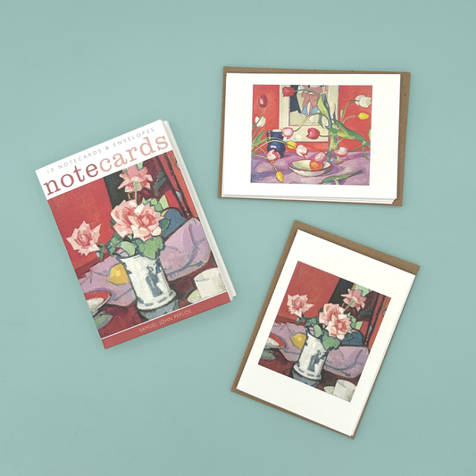Set of note cards with floral designs on a teal background