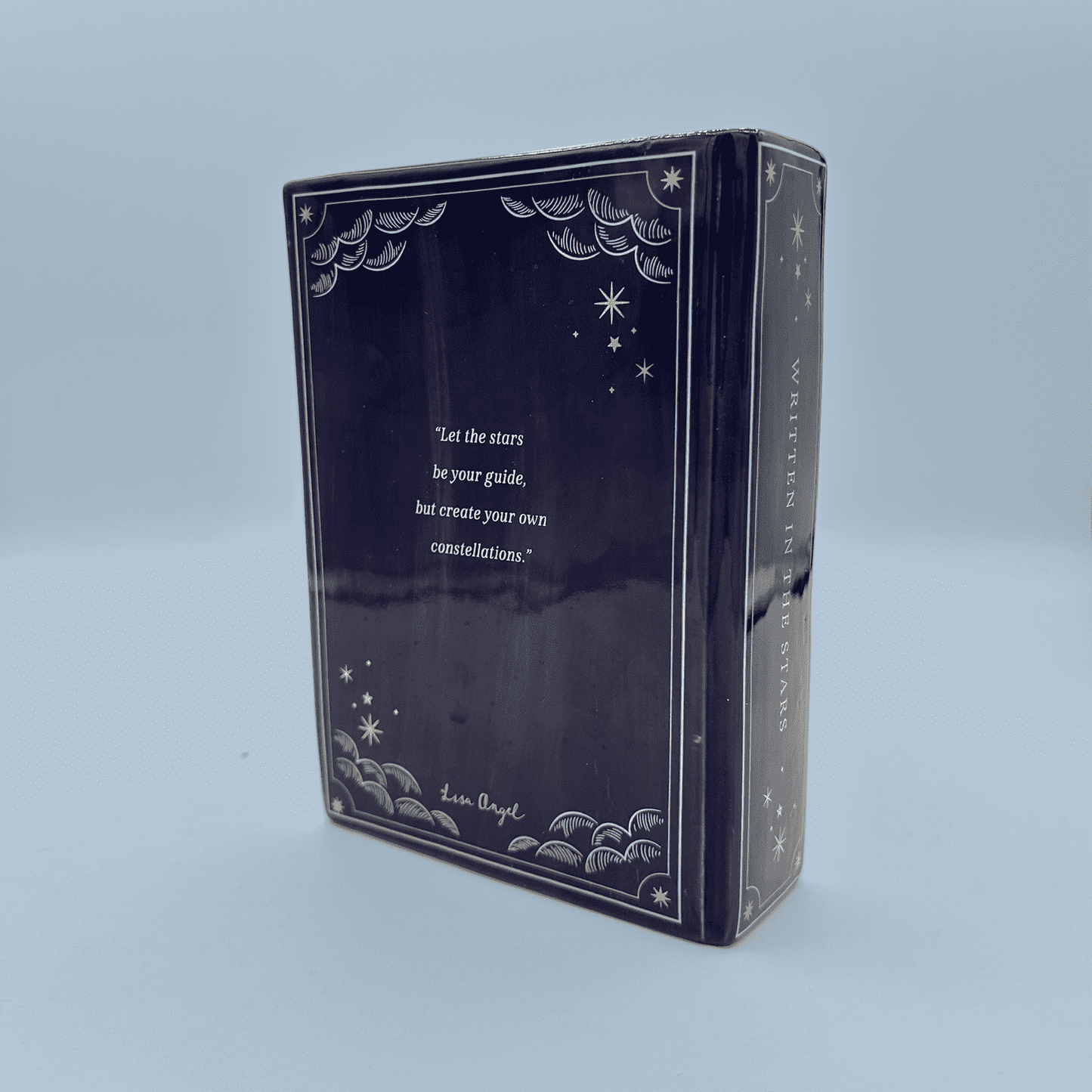 Decorative box vase with star and moon designs on a blue background