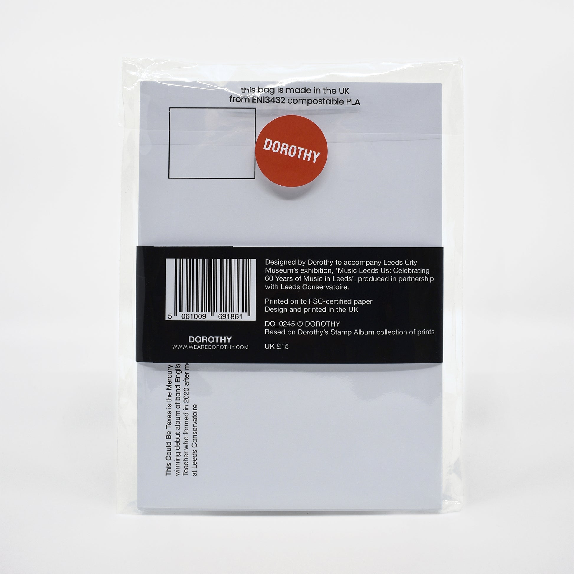 Packaged postcard pack with a label featuring the brand 'DOROTHY' on a white background