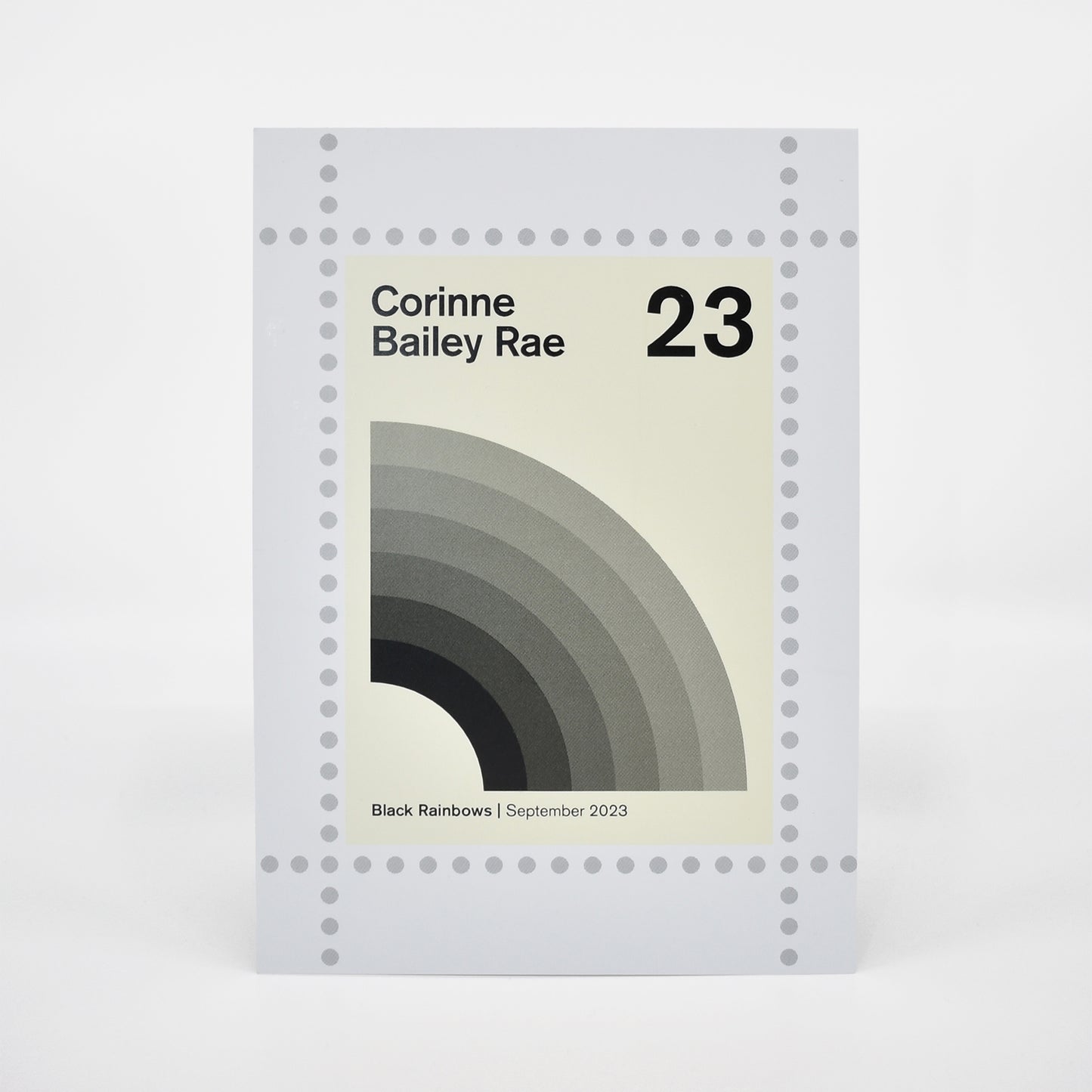 Postcard cover for Corinne Bailey Rae's 'Black Rainbows' with a minimalistic design.