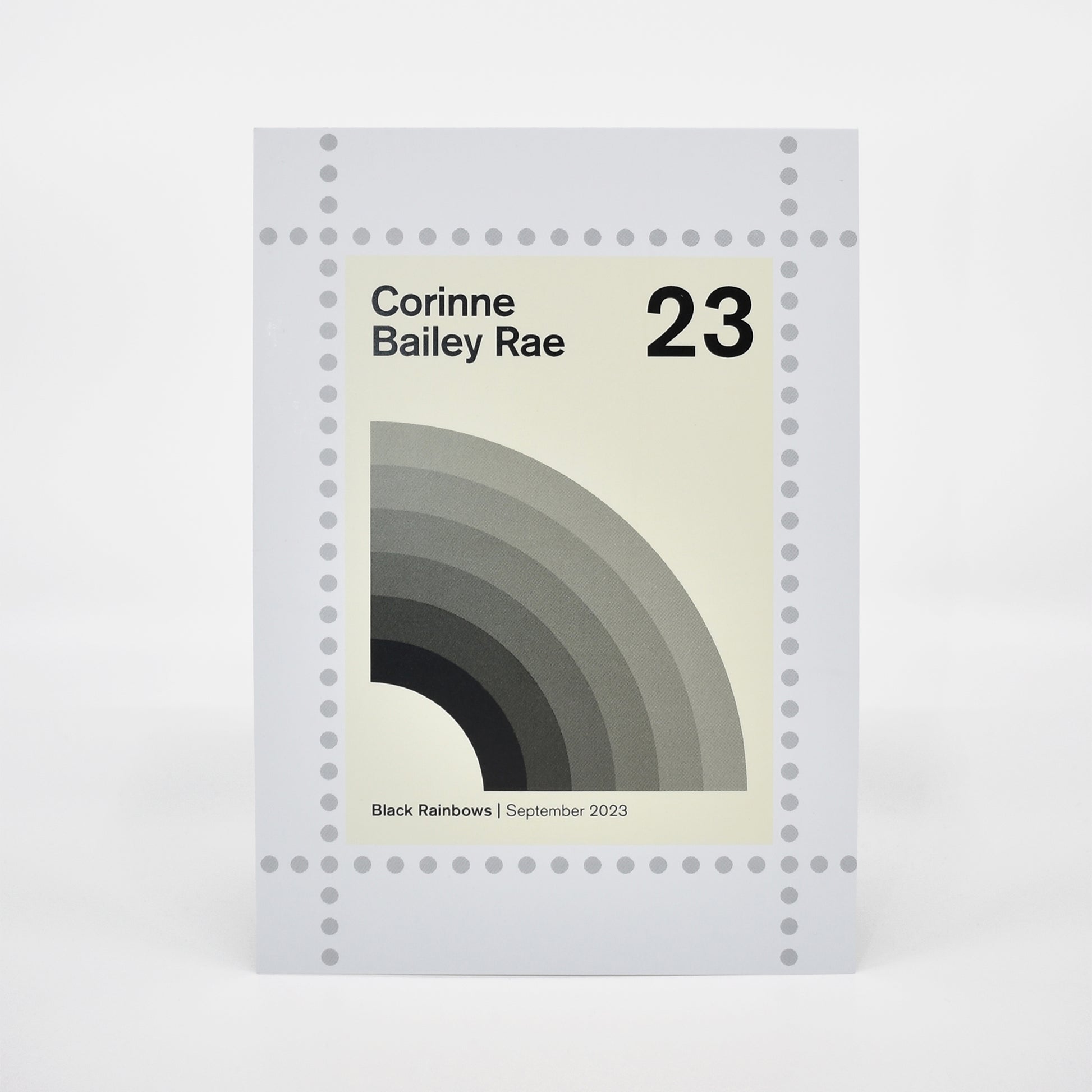 Postcard cover for Corinne Bailey Rae's 'Black Rainbows' with a minimalistic design.
