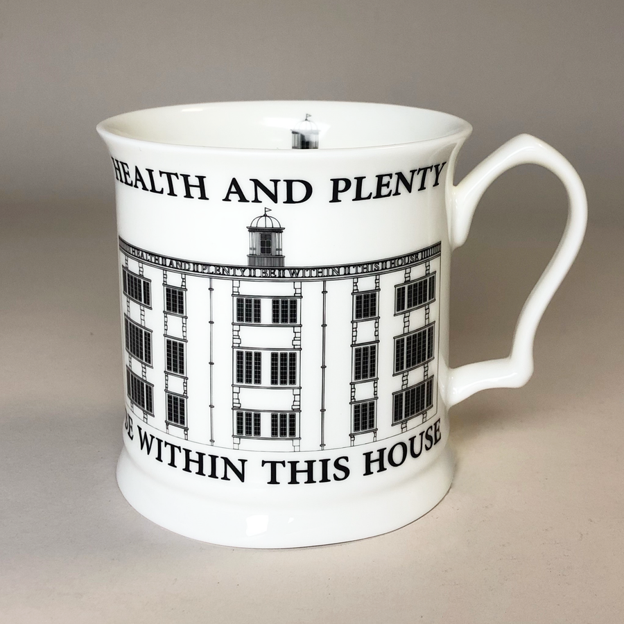 A white bone china mug with black text and design, featuring an architectural building and the phrases 'Health and Plenty' and 'Within This House'.