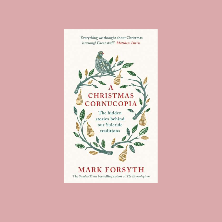 Book cover of 'A Christmas Cornucopia' by Mark Forsyth, featuring a cream background with a green and gold wreath illustration and red text, centered on a dusty pink background.