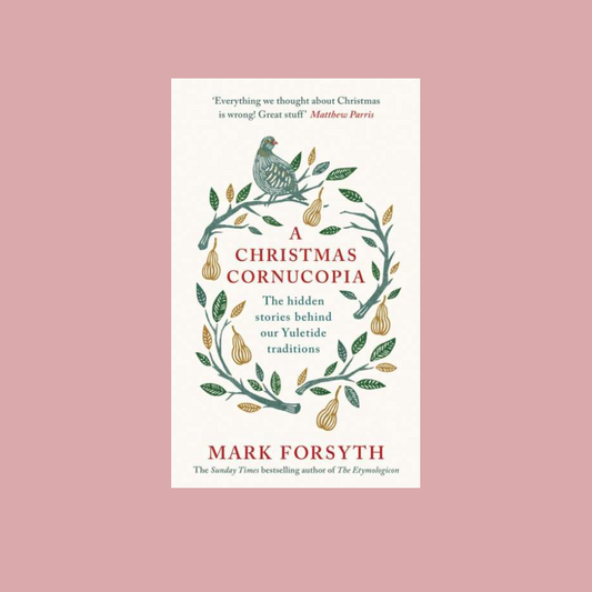 Book cover of 'A Christmas Cornucopia' by Mark Forsyth, featuring a cream background with a green and gold wreath illustration and red text, centered on a dusty pink background.