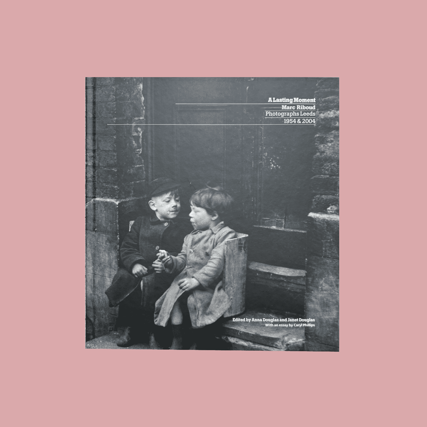 Book cover with black and white photograph of two children sitting on a bench, text overlay.