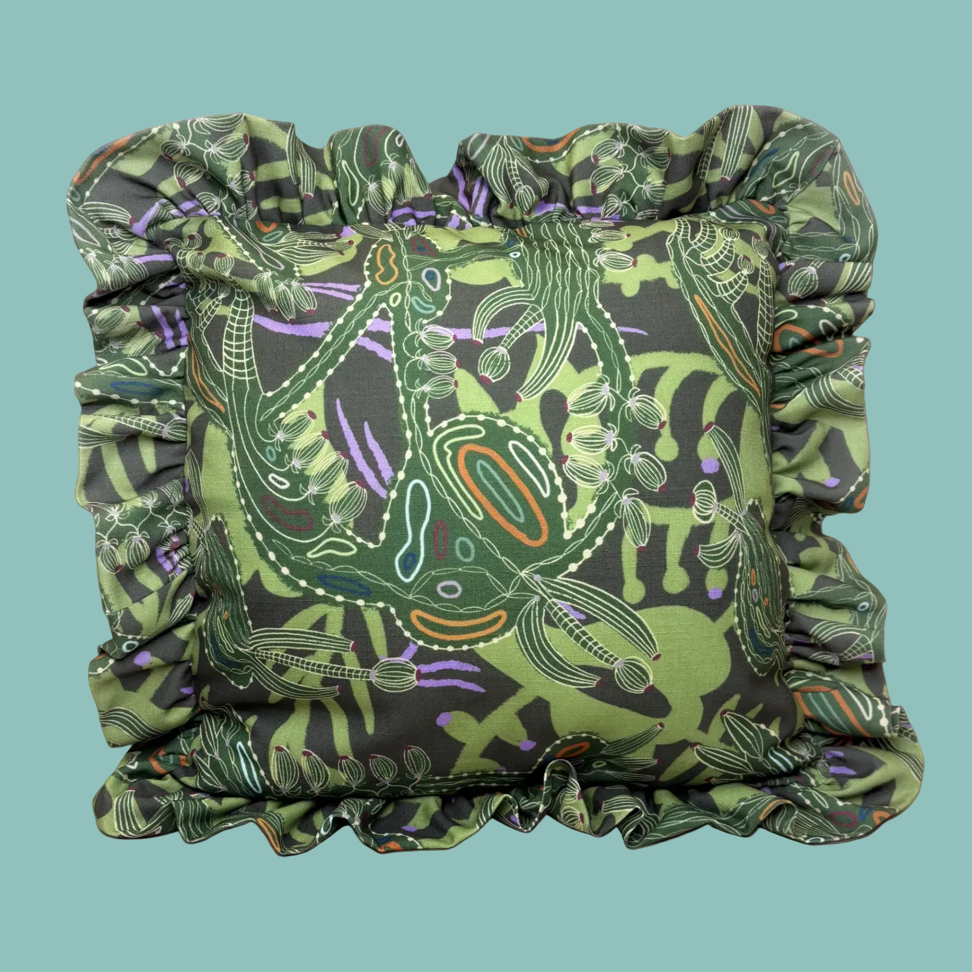 Decorative pillow with green and black pattern on a white background