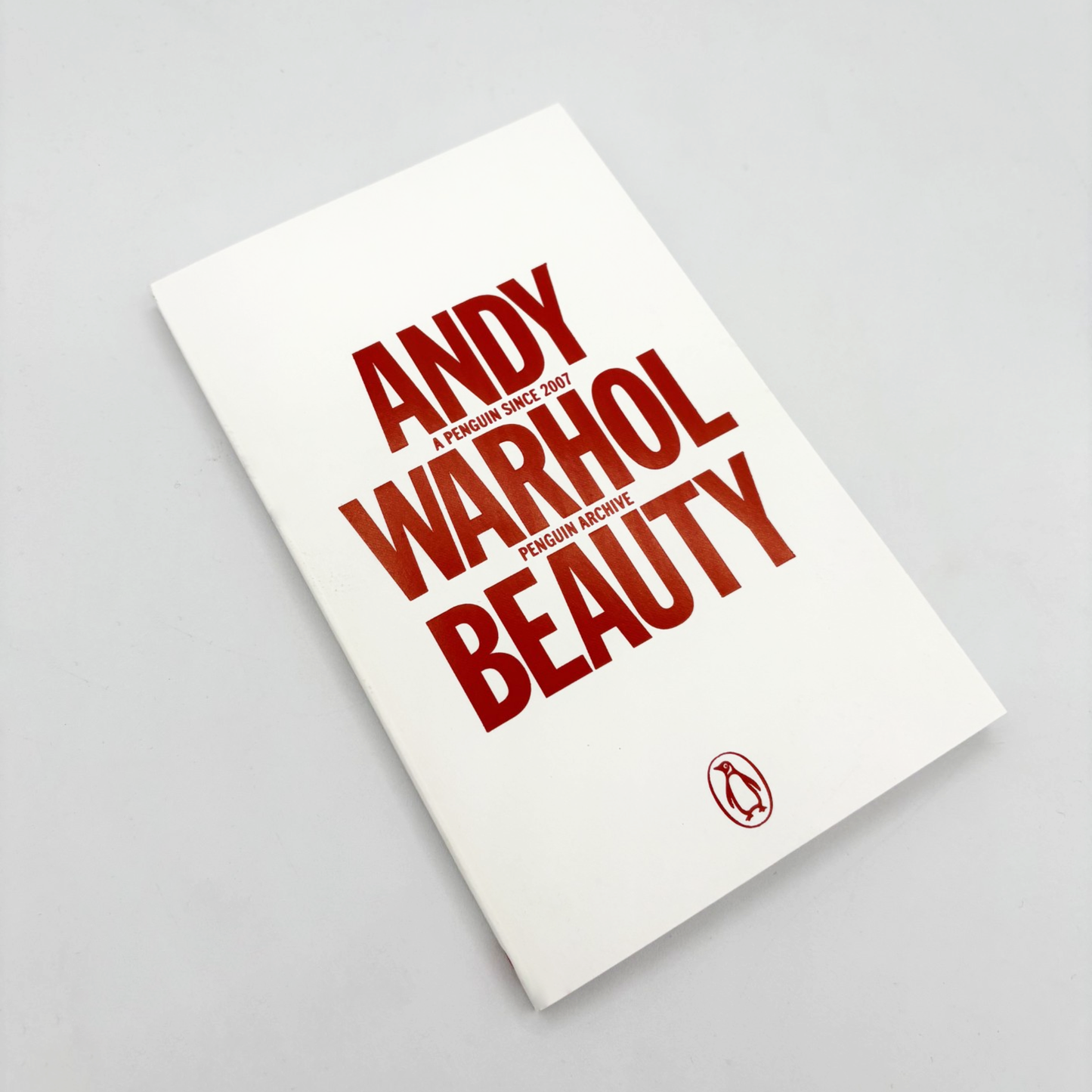 Book titled 'Andy Warhol Beauty' with red text on a white background