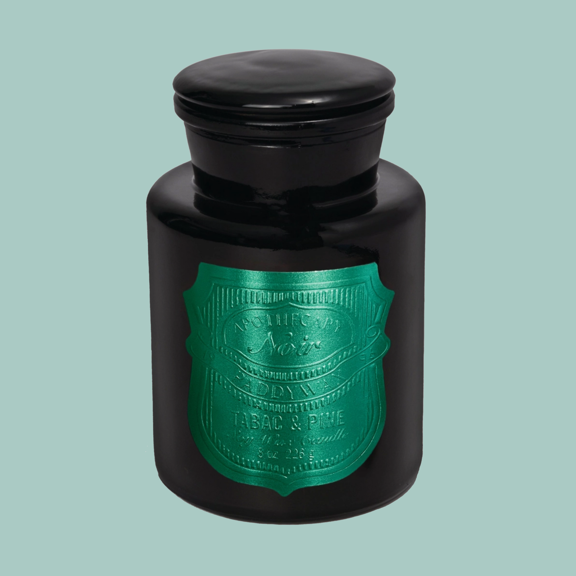 Black jar with a green label on a light blue background