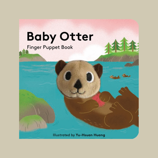 Front cover of the children's book 'Baby Otter Finger Puppet Book' showing an illustrated baby otter floating on its back in blue water, with a pink sky and green trees in the background.