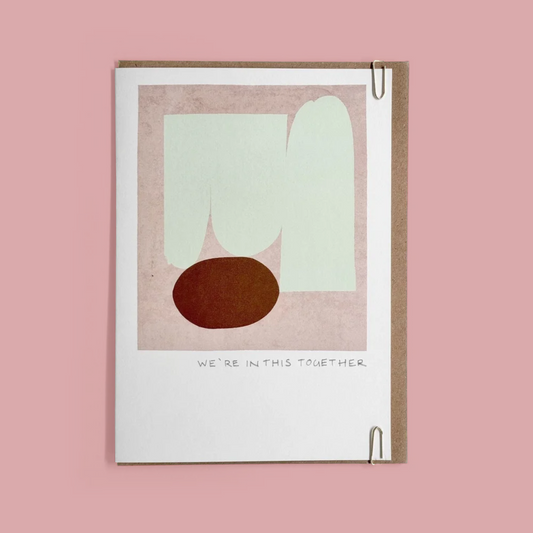 Greeting card with abstract design and 'We're In This Together' text on a pink background