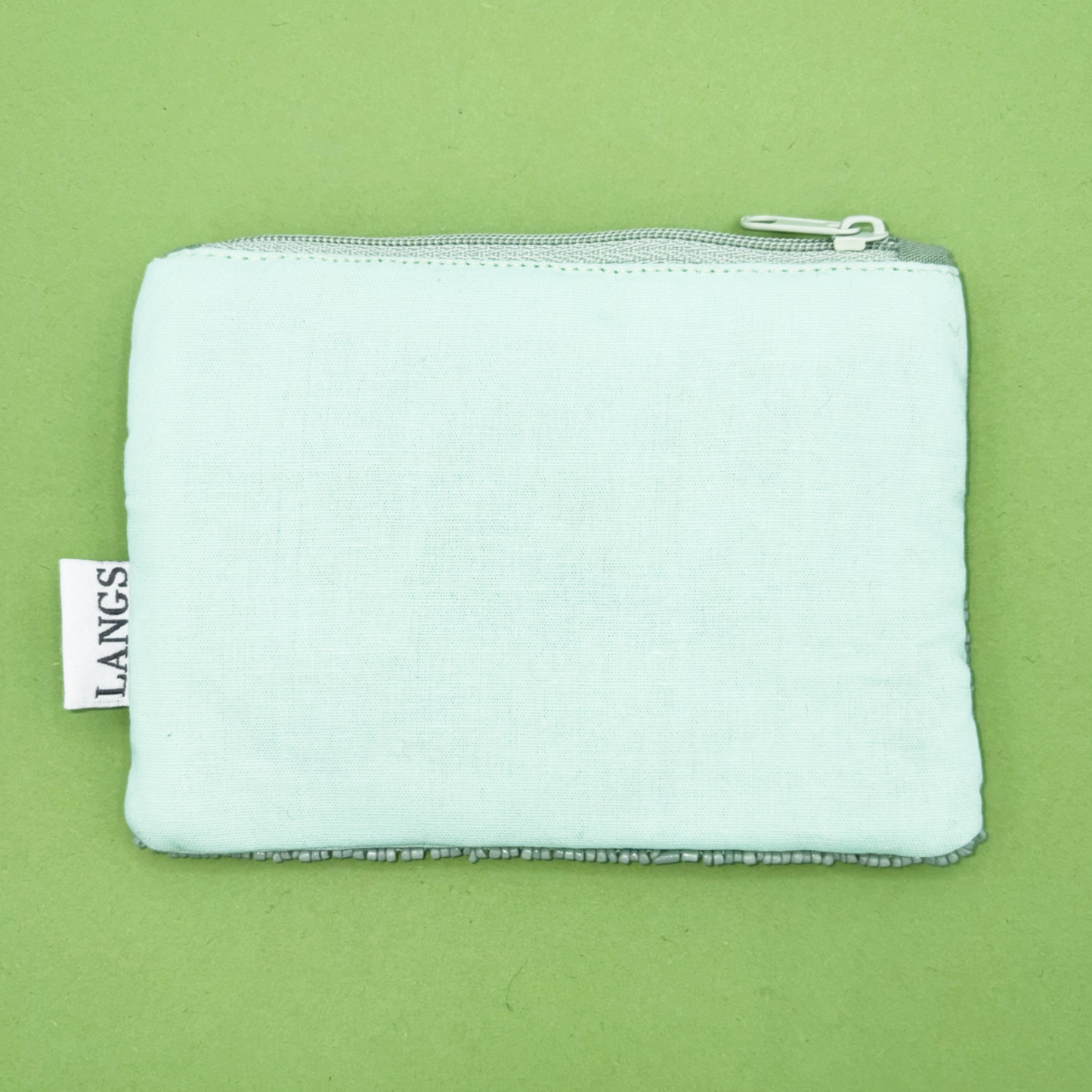 Light blue pouch with a zipper on a green background, featuring the brand 'LANGS'.