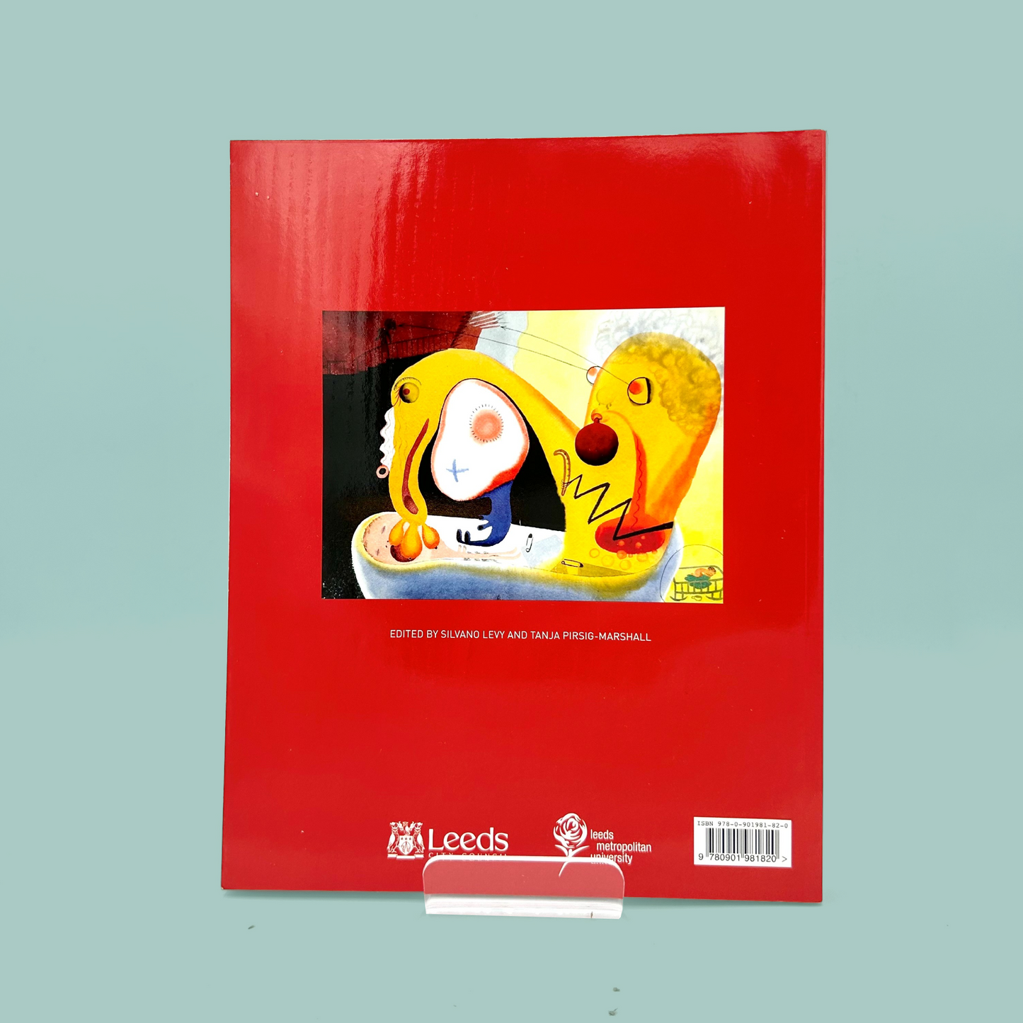Red book cover with a colorful illustration of a face on a light blue background