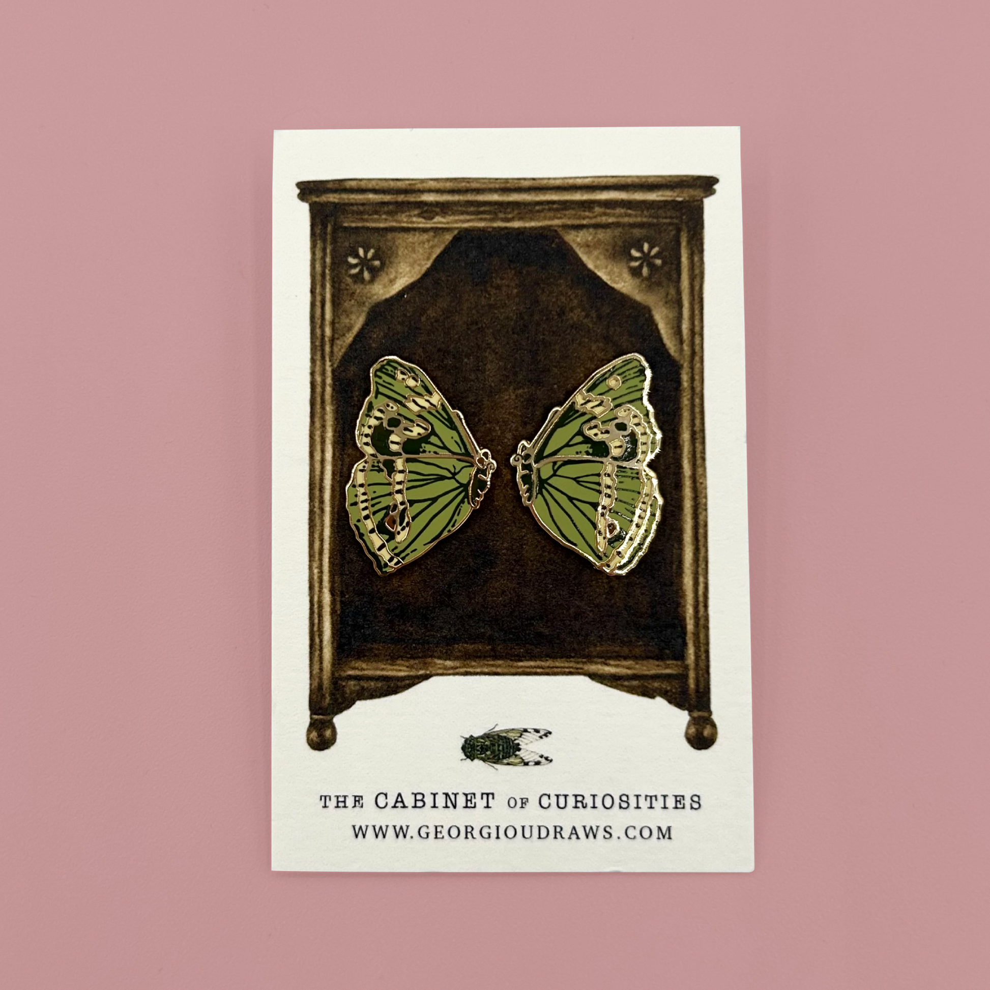 2 butterfly wing pins on an illustrated backing card. 