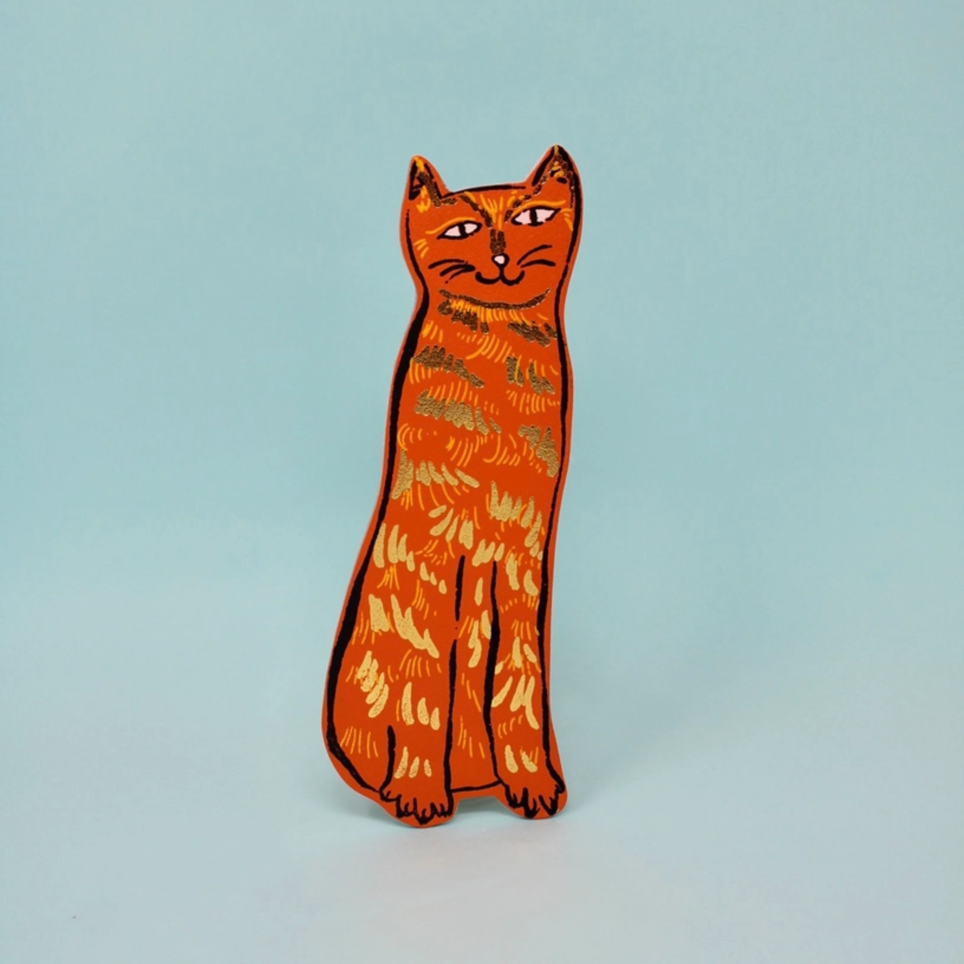 orange cat leather bookmark with gold foiling on a blue background
