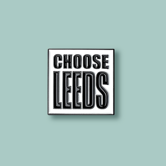 Square badge with 'CHOOSE LEEDS' text on a white background. The pin is placed on a light blue background.