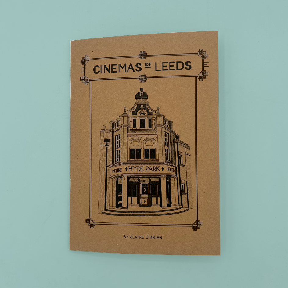 A kraft paper zine cover titled "CINEMAS OF LEEDS" by Claire O'Brien, featuring a black line drawing of a vintage cinema building,  photographed against a light blue backdrop.