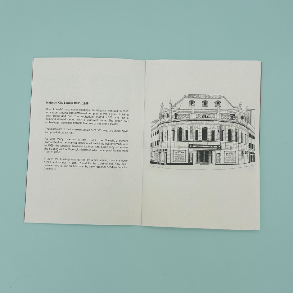 An open zine laid flat on a light blue background. The left page contains a short text about the former Majestic Cinema on City Square. 