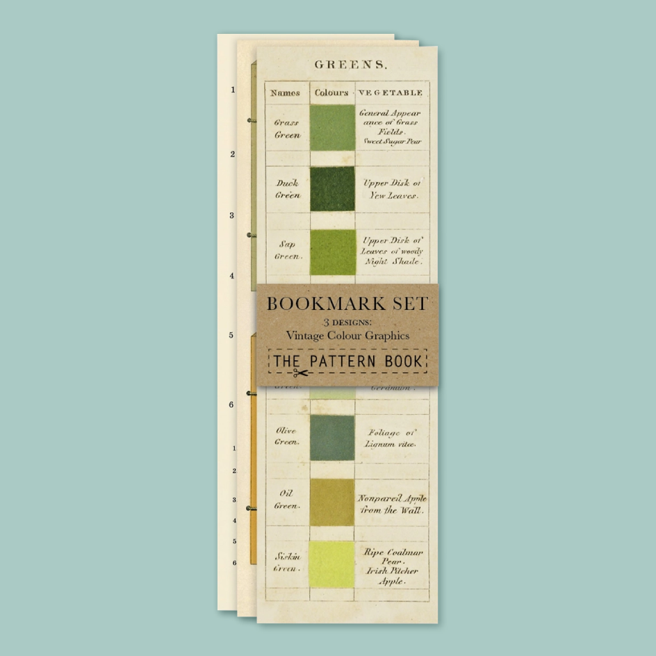 A bookmark featuring green color charts with vegetable names and color swatches, printed on cream-colored paper with a brown band.