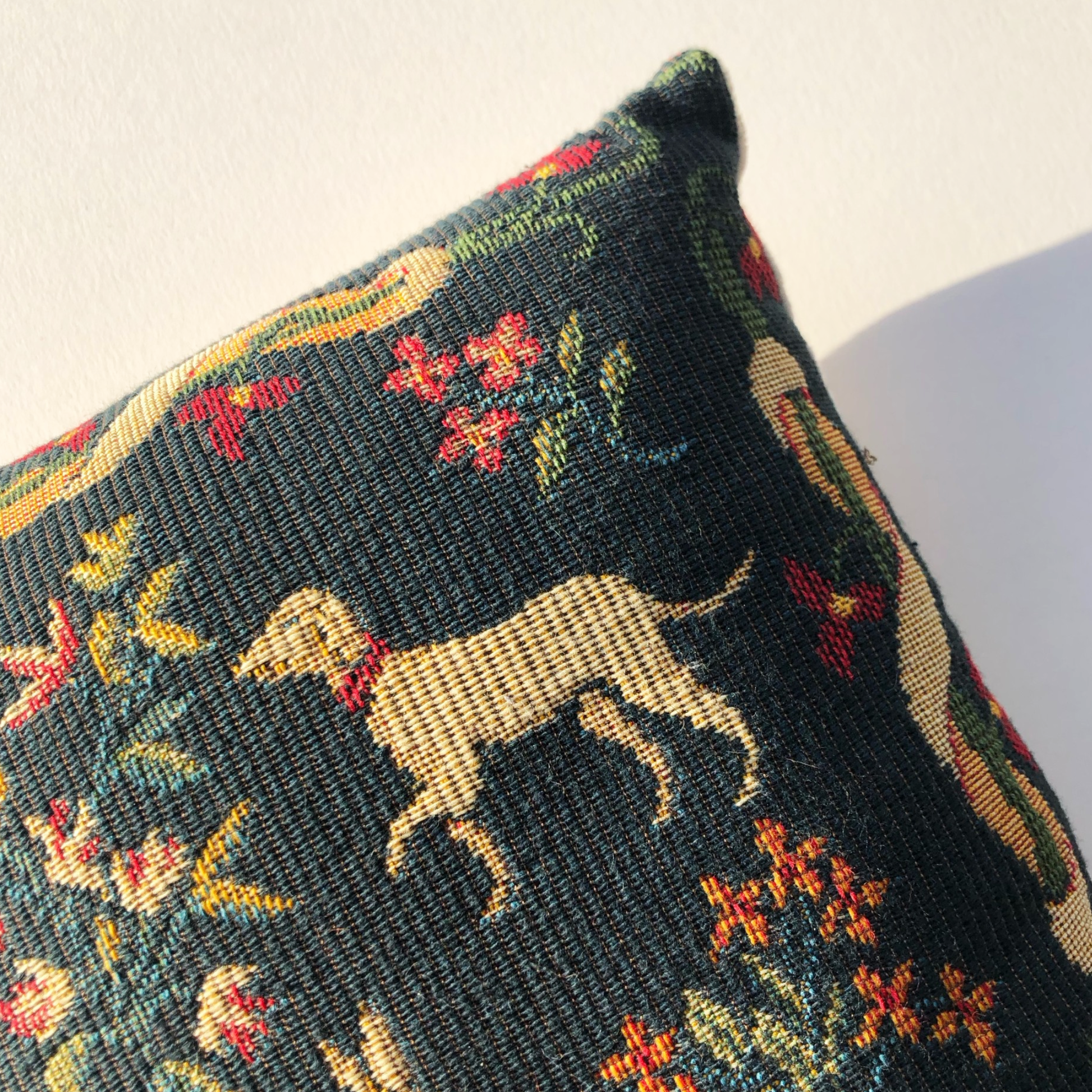 Corner of a cushion of a woven dog on a natural background