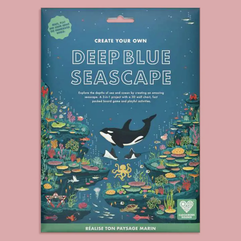 A packaged craft kit titled "Deep Blue Seascapes" with illustrated underwater artwork, including a whale, octopus, coral, and fish, on a pink background.