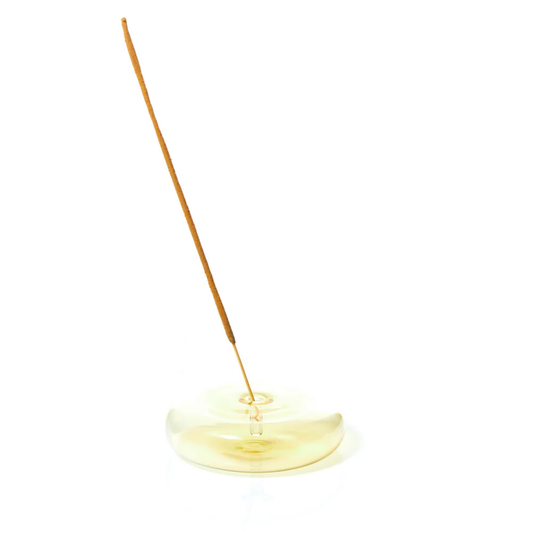 Incense stick holder with a single incense stick on a white background