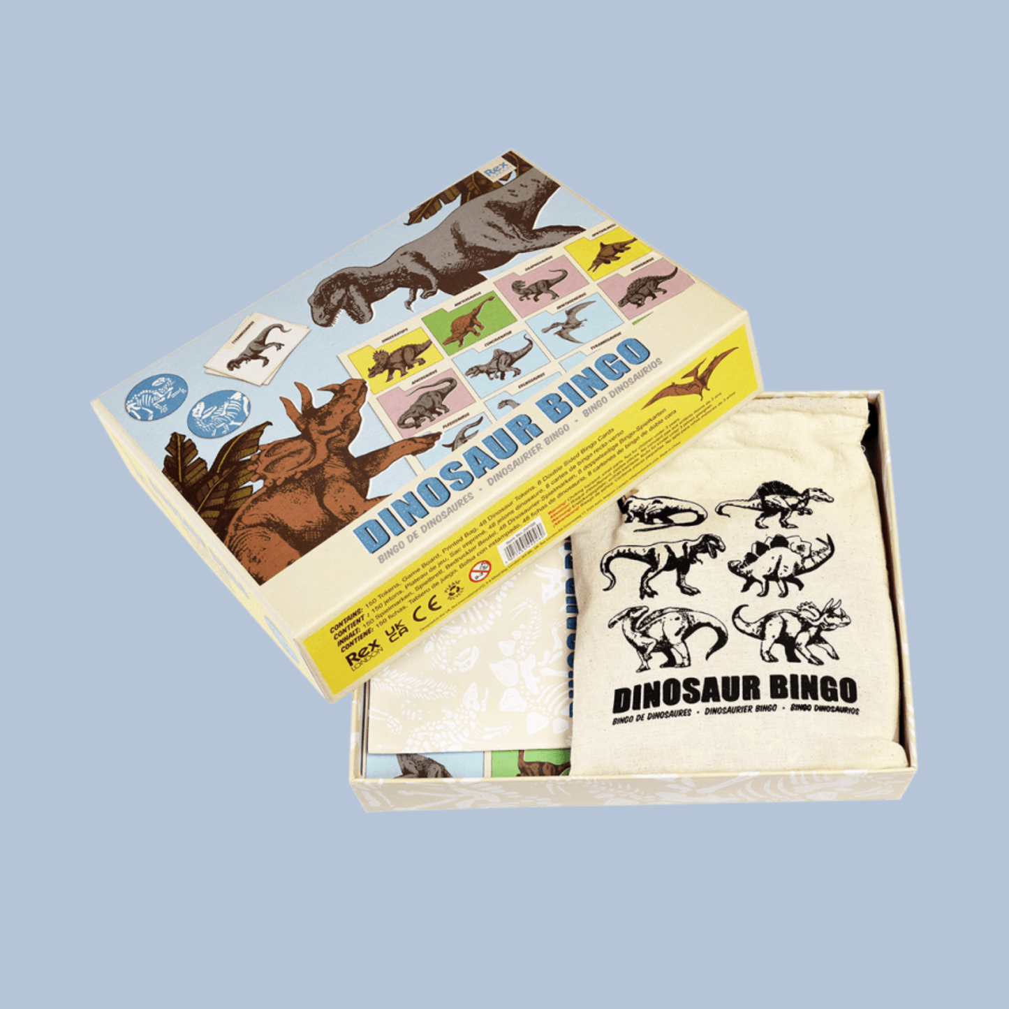 Dinosaur bingo game set with box and cards on a light blue background