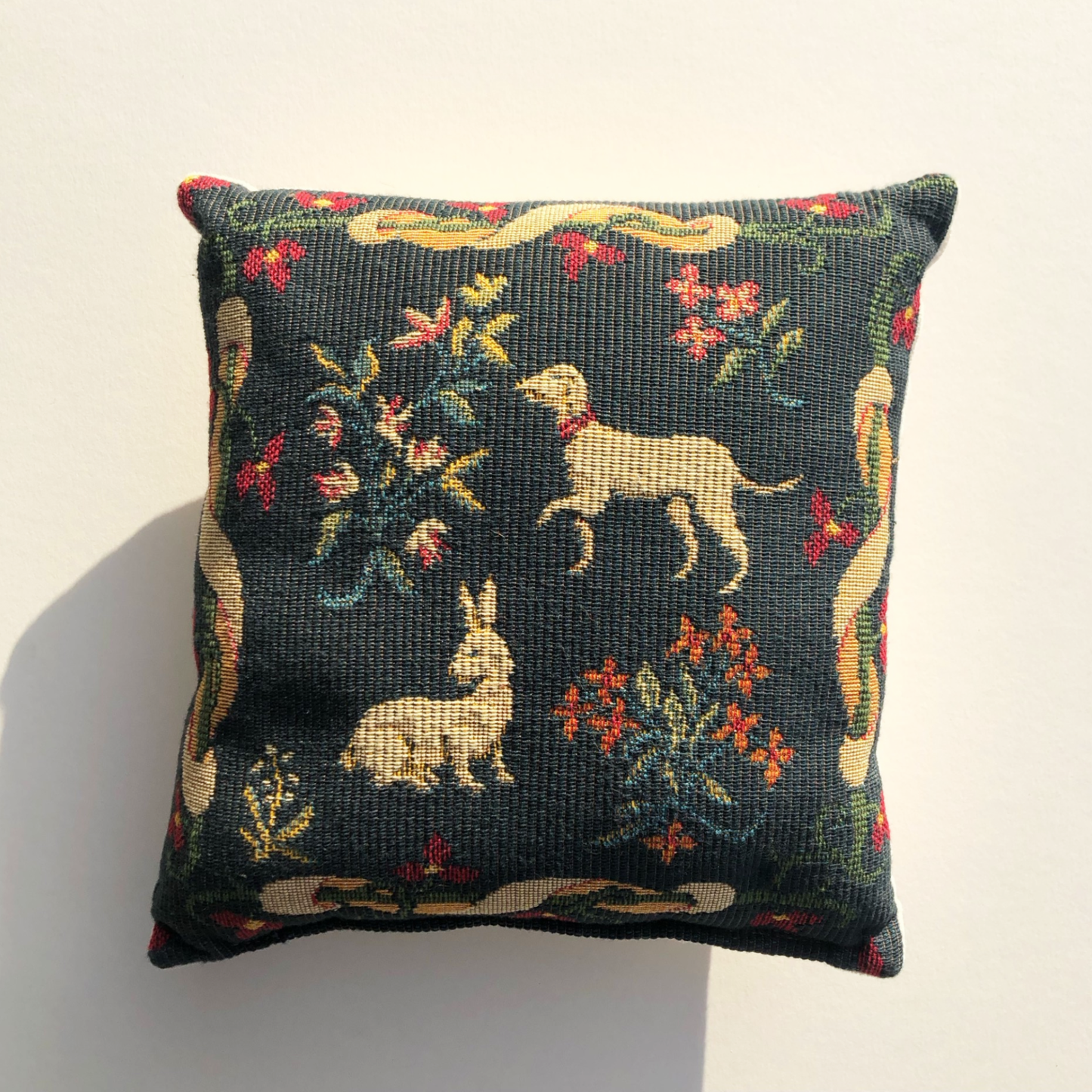 Medieval tapestry on a mini cushion on a natural background