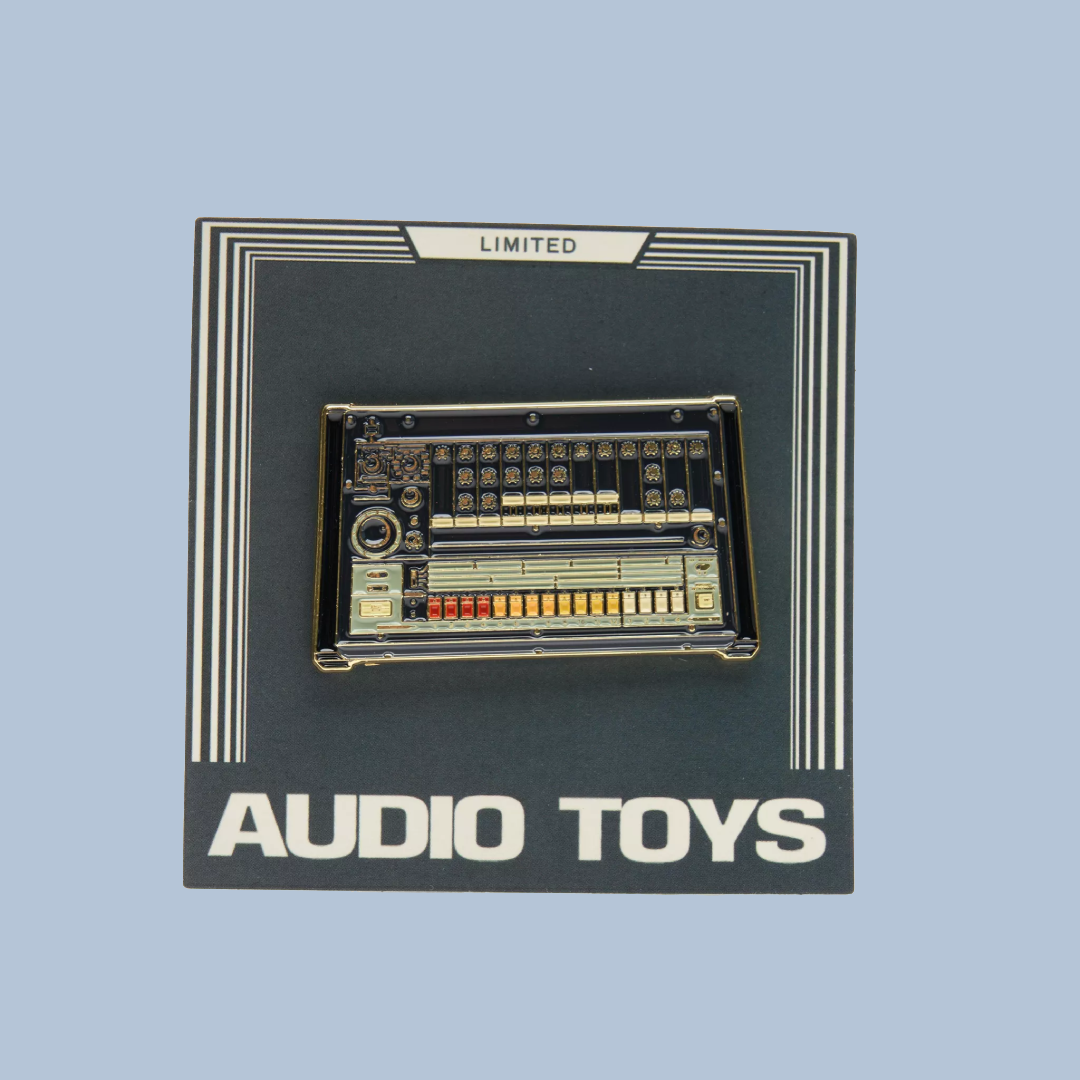 Pin with electronic component design on a black card labeled 'Audio Toys' and 'Limited'.