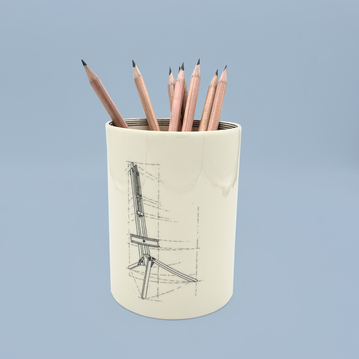 Pencil holder with pencils on a light blue background