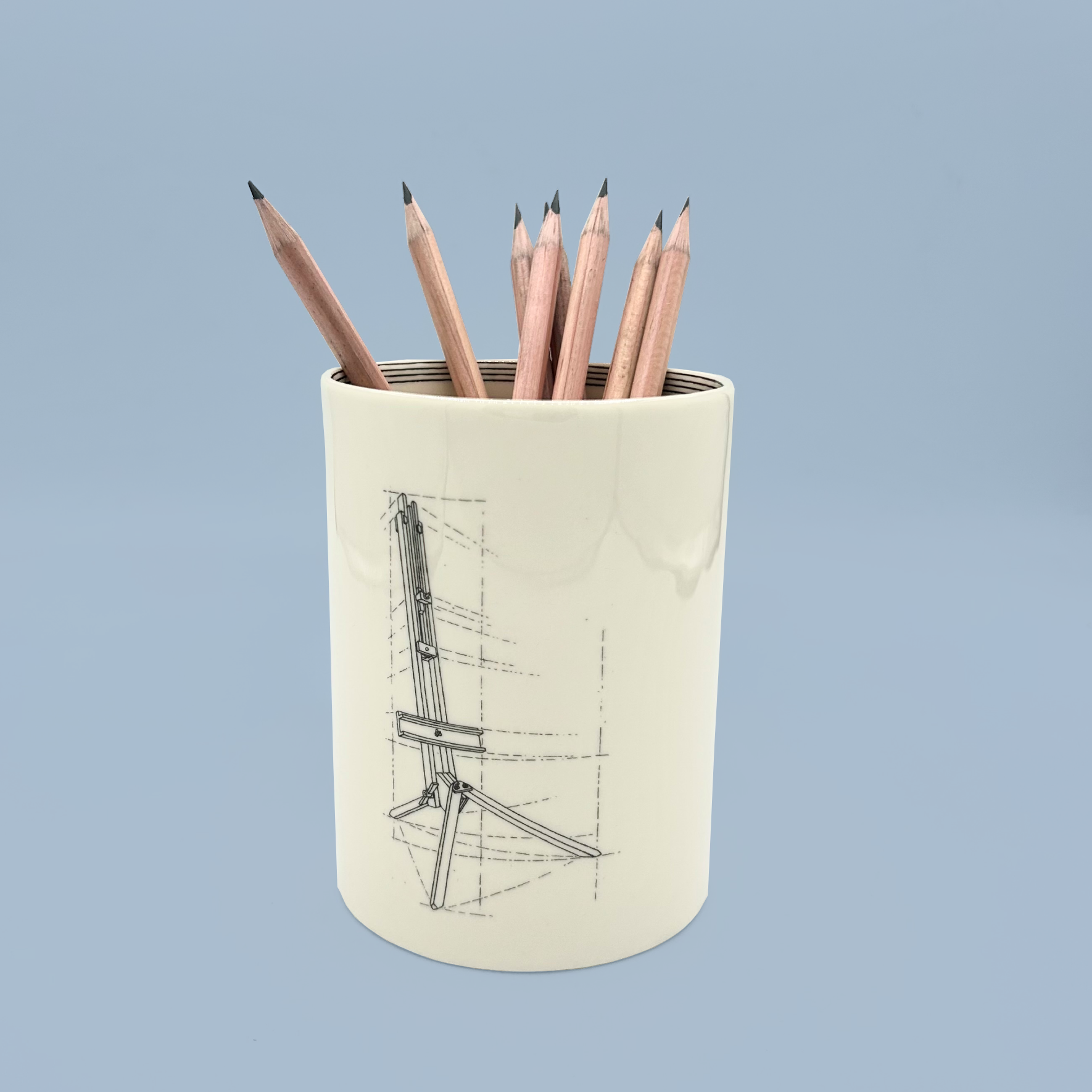 Pencil holder with pencils on a light blue background