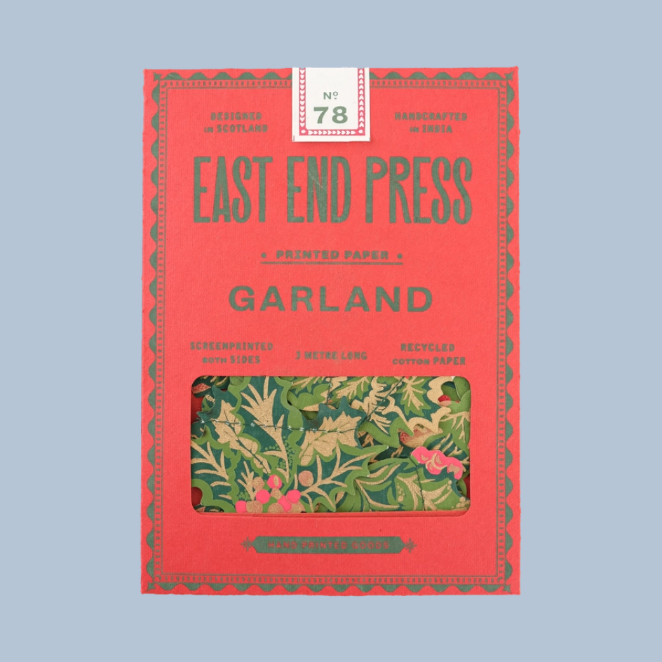 East End Press Garland No. 78 on Screenprinted Papers in a red box with a clear window showing the green and pink patterned papers inside, set against a solid light blue background.