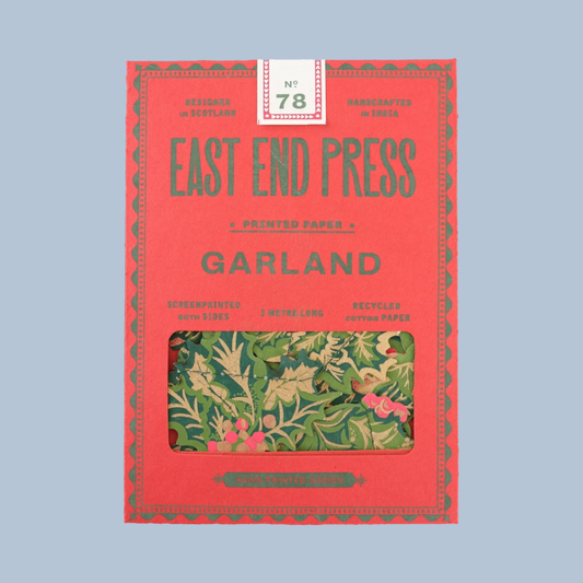 East End Press Garland No. 78 on Screenprinted Papers in a red box with a clear window showing the green and pink patterned papers inside, set against a solid light blue background.