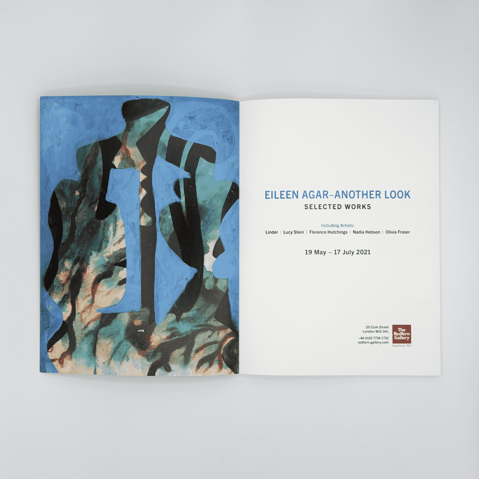 Open book with abstract art on one page and text on the other, on a light gray background