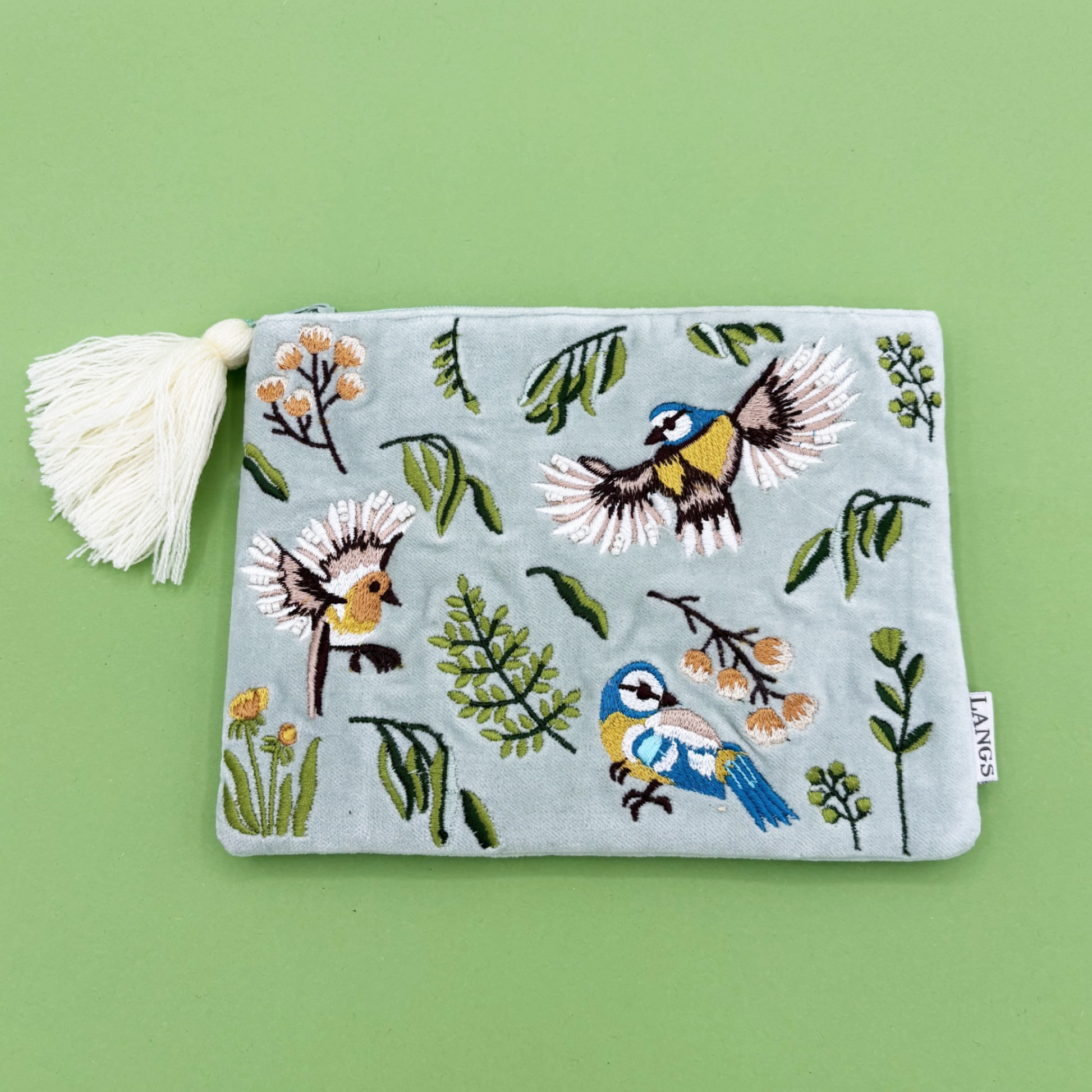 Embroidered pouch with bird designs on a green background