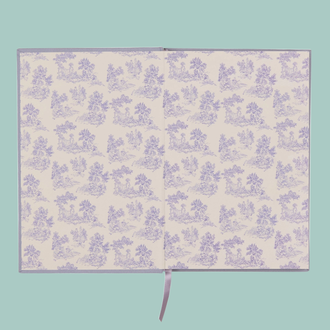 White and lilac floral patterned end pages of a notebook, on a blue background. 