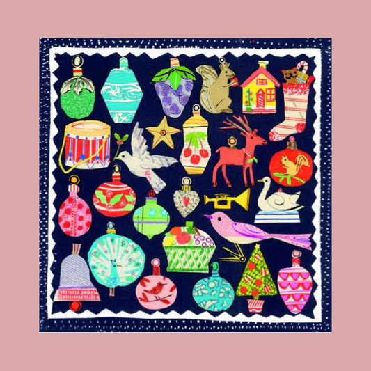 A square image featuring a colorful Christmas-themed illustration on a navy blue background with a white scalloped border. The design includes ornaments, a stocking, a house, a drum, a star, a deer, a swan, and birds in bright pink, green, red, yellow, and purple tones, shown against a solid dusty pink background.