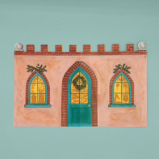 A card advent calendar depicting a whimsical peach-colored building facade with a teal door, two arched windows with yellow-gold panes, brick trim, and greenery, shown against a solid pale aqua background.