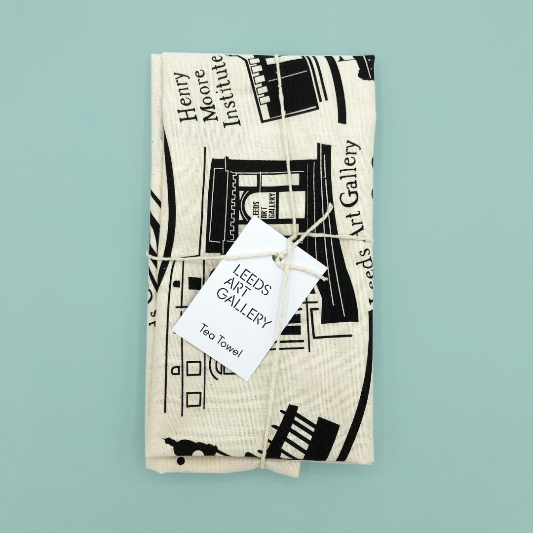 Tea towel with black and white design and branded Leeds Art Gallery tag on a light blue background